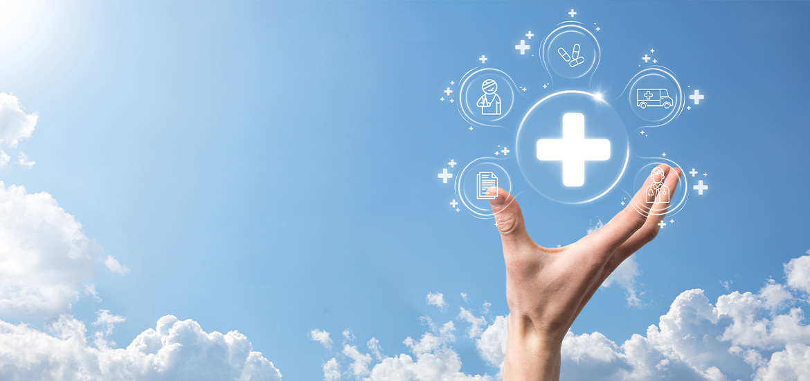 Hand holding connected healthcare icons against a blue sky and clouds