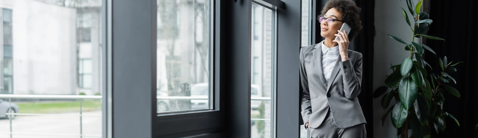 Business professional speaking on the phone in a bright office